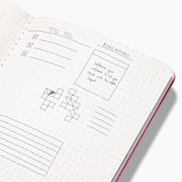 Inside the Everyday Notebook in Dotted with writing on a white background. 