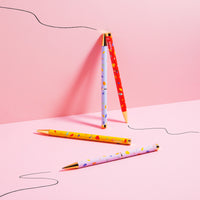 The PK Pattern Twist Pen Set of 4 on a pink background. 