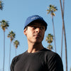 Model wearing the Thinking Cap in Blue on an outdoor setting.