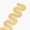 A close up of the Brass Bookmark in Wave on a white background. 